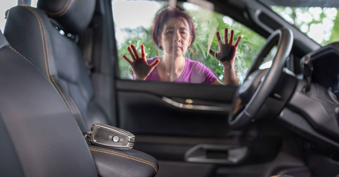 A woman presses her face against a car window. She looks at her keys, which are locked inside the car.